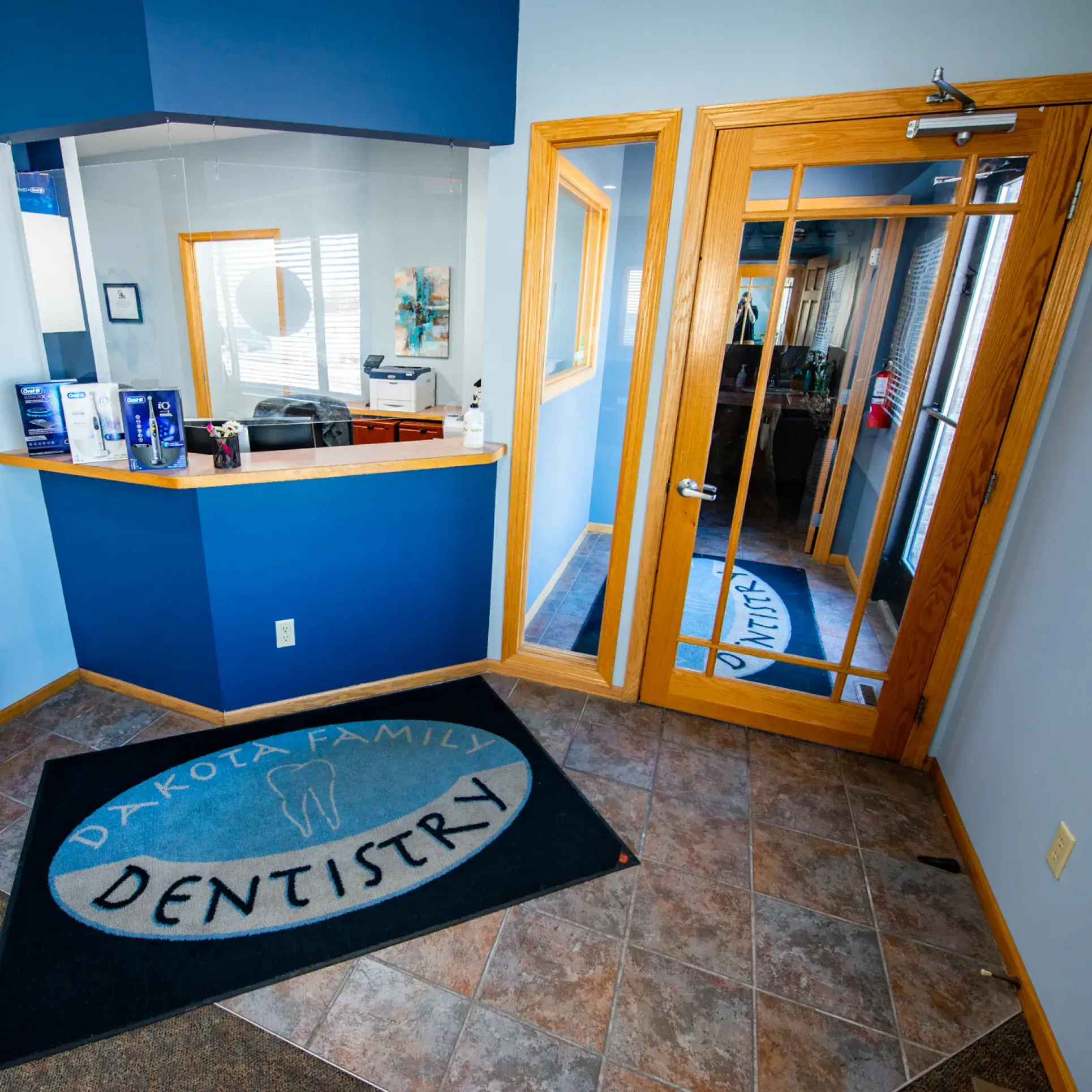 Sign for Dakota Family Dentistry on a brick building, rated 5 stars by over 230 patients.