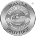 A round silver badge with text "Master Fastbraces Straight Teeth Provider."